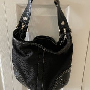 Coach purse - black with buckle strap and tassel on the zipper.